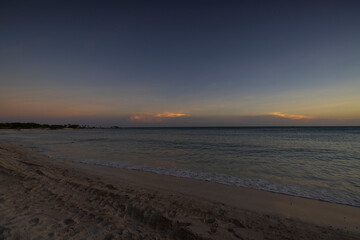 Beautiful view of sunset in Atlantic ocean from sandy beach of island of Aruba.