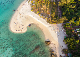 Beautiful Koh Lipe Island with tourist relaxing on the beach in tropical sea