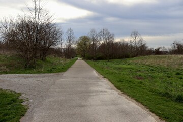 Fototapeta na wymiar The empty pathway on a cloudy spring day.
