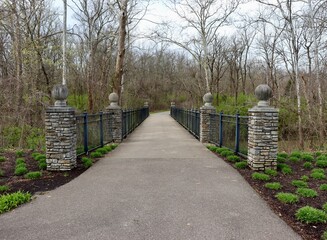 The pathway bridge in the park on a cloudy spring day.