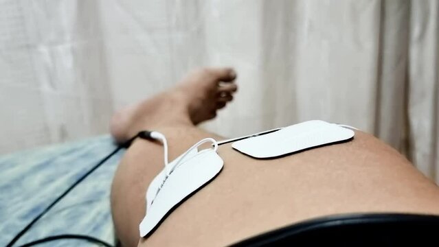 Patient receiving interferential therapy as part of the physiotherapy course to heal injured ankle foot