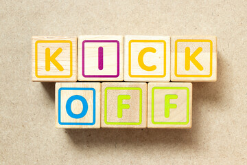 Wooden alphabet letter block in word kick off on wood background