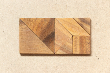 Wooden tangram in square or rectangle shape on wood background