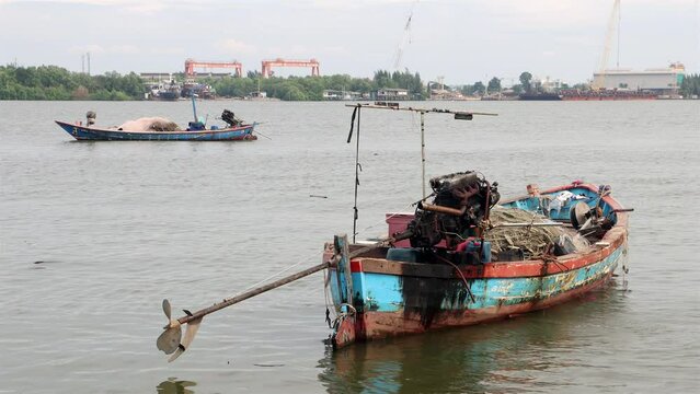 A two fishing boats loaded with nets is moor on the Chao Phraya River, Thailand