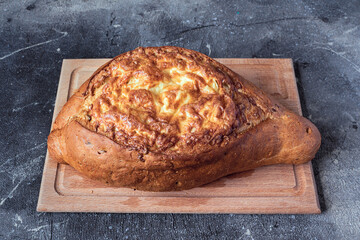 homemade bread with cheese and garlic on a wooden board