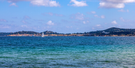 View from Port Grimaud towards Saint Tropez with the bay, the Mediterranean Sea and ships and the harbour