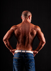 Athlete bodybuilder on a black background
