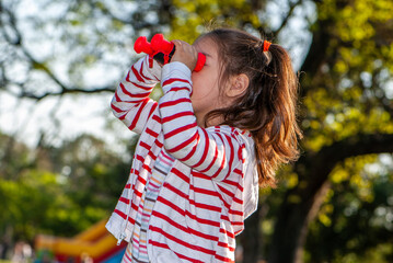 Child with binoculars in the park