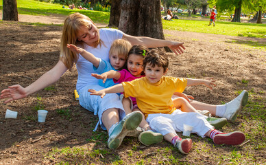 Joyful family in the park on the grass