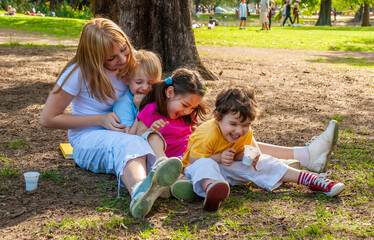 Joyful family in the park on the grass
