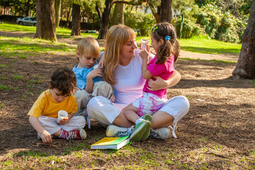 Joyful family in the park on the grass