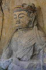 Usuki, Japan - May 1, 2023: Detail of one of the Usuki Stone Buddhas. They are a set of sculptures carved in rock during the 12th century in Usuki, Japan.
