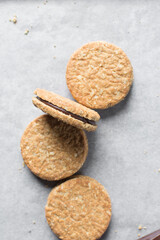 top view of oat cookies with chocolate filling, homemade oatmeal cookies filled with chocolate ganache, thin oat biscuits with chocolate ganache