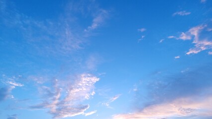 Nature view of sun, sky, and clouds. White clouds flying in the blue sky.