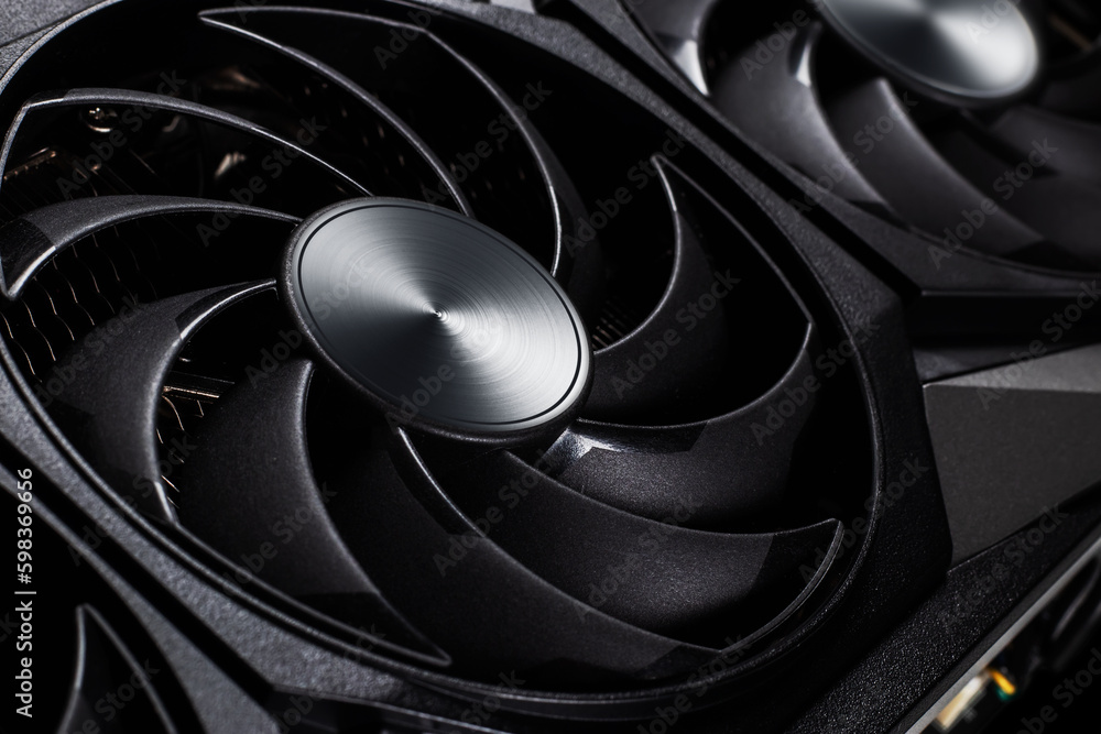 Poster video card with three coolers from the computer on a dark background.concept computer harware.