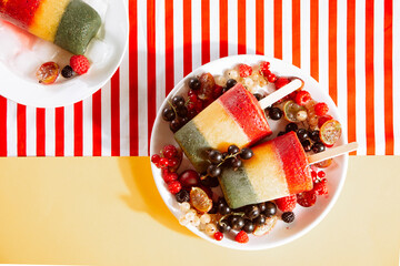 Homemade tasty vegan berries ice cream layered colorful popsicles. Summer dessert. Top view