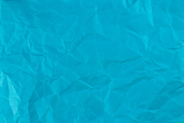 Clean blue paper, wrinkled, abstract background.