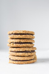 oat cookies with chocolate filling, homemade oatmeal cookies filled with chocolate ganache, thin oat biscuits with chocolate ganache