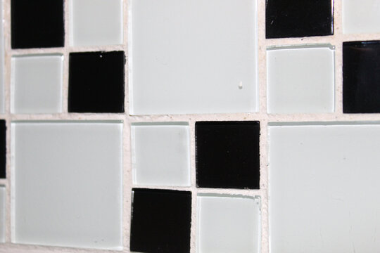 Texture in small and large geometric squares with predominance of white color..