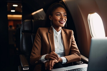African american businesswoman with laptop on airplane seated in business class. Generative AI. - obrazy, fototapety, plakaty