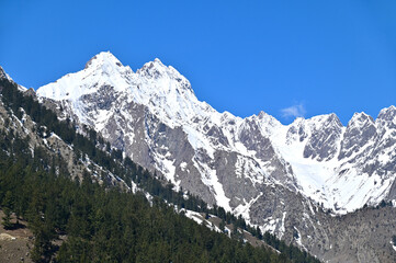 Fototapeta na wymiar Snowy Mountain Peak at Naltar Valley in Northern Pakistan