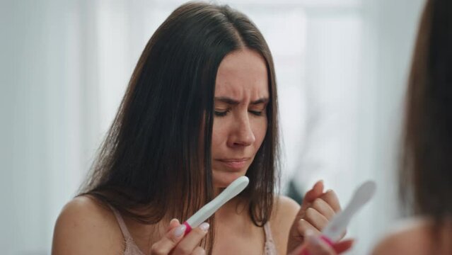 Stressed girl holding pregnancy test mirror place. Woman sad of unplanned baby Generative AI