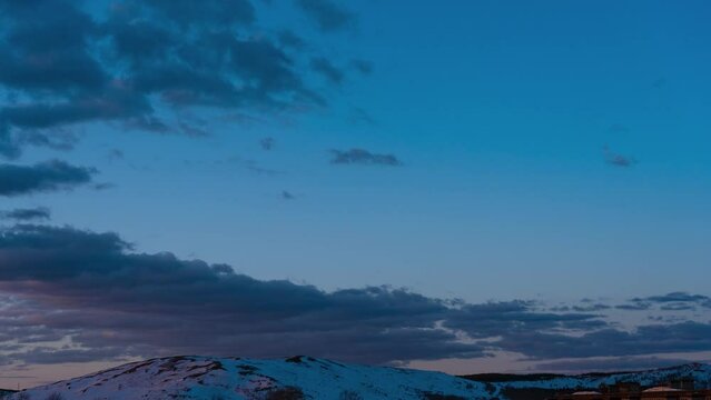 Winter landscape. Sunrise illuminates the clouds over the hills Generative AI