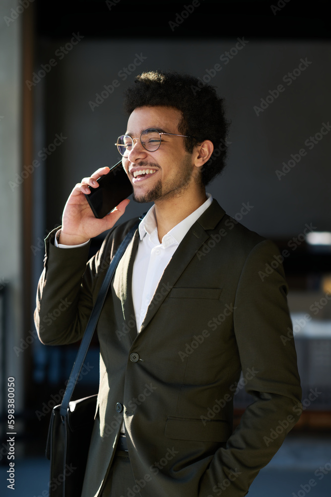 Aufkleber happy young businessman with mobile phone by ear talking to colleague or making appointment with cli