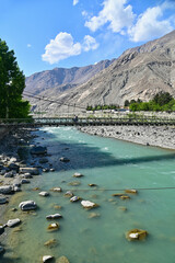 Turquouse Gilgit River and Gilgit Bridge in Gilgit District, Northern Pakistan