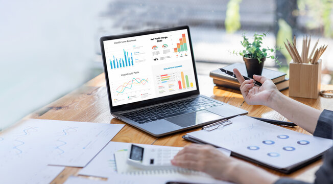 Financial Businesswomen analyze the graph of the company's performance to create profits and growth, Market research reports and income statistics, Financial and Accounting concept.	