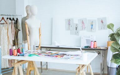 Background of interior tailor shop or room with nobody, there are mannequin, clothes, thread,...