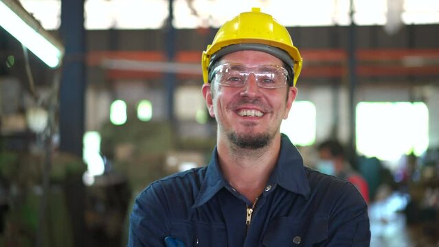 mechanical engineer get dressing before going to work in factory. Male mechanical technician wearing a protective goggles - glasses and vest.