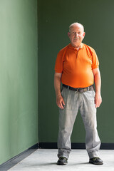 Full length portrait of grey haired senior man with mustache wearing eyeglasses