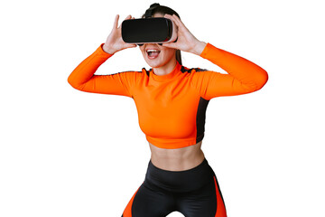 Excited Caucasian girl in orange sportswear using virtual reality headset with wide opened mouth against transparent background. Technologies, sport. For caucasian brunette girl trains by vr glasses