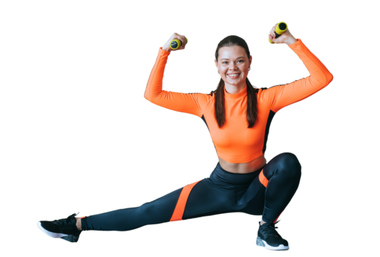 Strong hispanic fit young woman in orange sportswear stretches legs bends hands holds dumbbells against transparent background looks at camera. Cheerful caucasian girl enjoying exercise at sport club. - Powered by Adobe