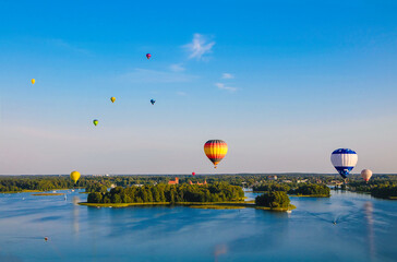Colorful hot air balloons flying over Trakai Castle