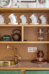Fototapeta na wymiar cupboard with accessories for Chinese tea ceremony in yoga studio, tea jar, kettle, sink, mugs