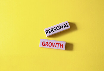 Personal growth symbol. Wooden blocks with words Personal growth. Beautiful yellow background. Business and Personal growth concept. Copy space.