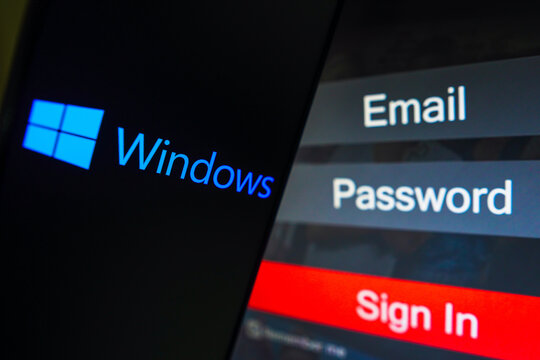 May 1, 2023, Brazil. In this photo illustration, the Microsoft Windows logo is displayed on a smartphone screen, next to a login screen, with email, password and sign in.