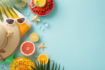 Bring on the sunshine and good times with sunglasses, cocktails, towel, hat. Top view flat lay on blue background with copyspace for text or advert