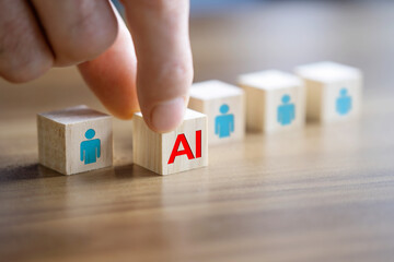 Man's hand pushes the AI written wooden cube forward. AI versus human concept.