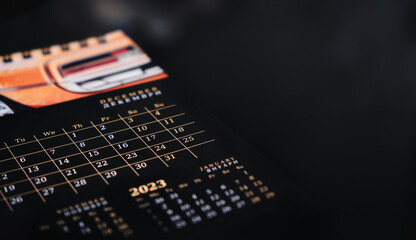 Calendar on a black background with a place for the inscription. Dark calendar. Stock photo of the calendar