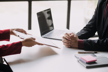 Financial analysts analyze business financial reports on a digital tablet planning investment project during a discussion at a meeting of corporate showing the results of their successful teamwork.