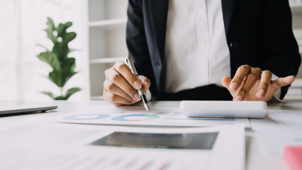 Financial analysts analyze business financial reports on a digital tablet planning investment project during a discussion at a meeting of corporate showing the results of their successful teamwork.