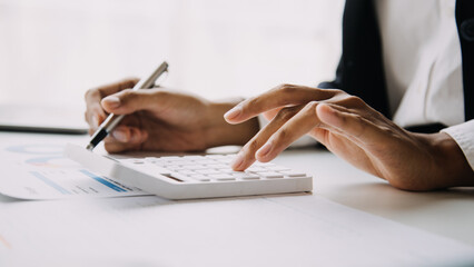 Financial analysts analyze business financial reports on a digital tablet planning investment project during a discussion at a meeting of corporate showing the results of their successful teamwork.