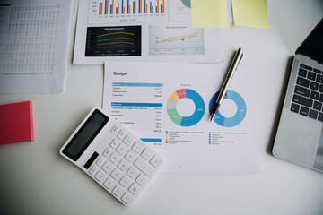 Financial analysts analyze business financial reports on a digital tablet planning investment project during a discussion at a meeting of corporate showing the results of their successful teamwork.