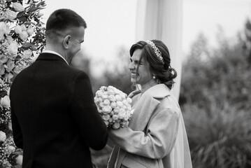 wedding ceremony of the newlyweds in a country cottage