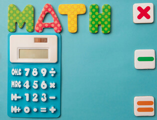 Fun math education with kid's calculator and colorful numbers with light blue background 