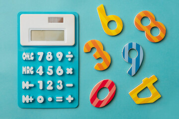 Kids learning math fun calculator and colorful numbers with light blue background