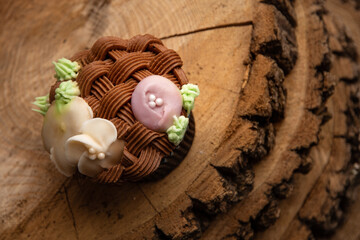 Easter Spring basket decorated cupcake on outdoors wood slice stand
